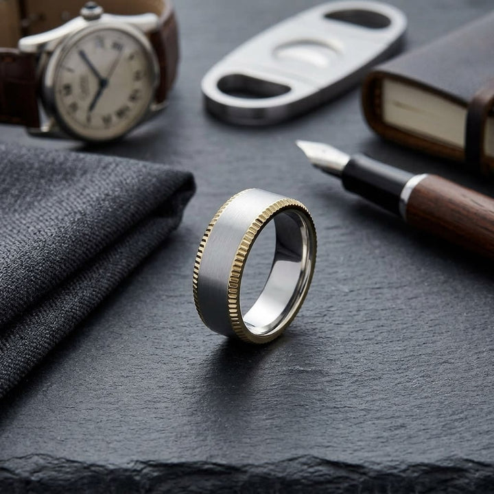 8mm Satin Finish Carved Wedding Band in 14K Two-Tone Gold, on walnut surface with pocket square
