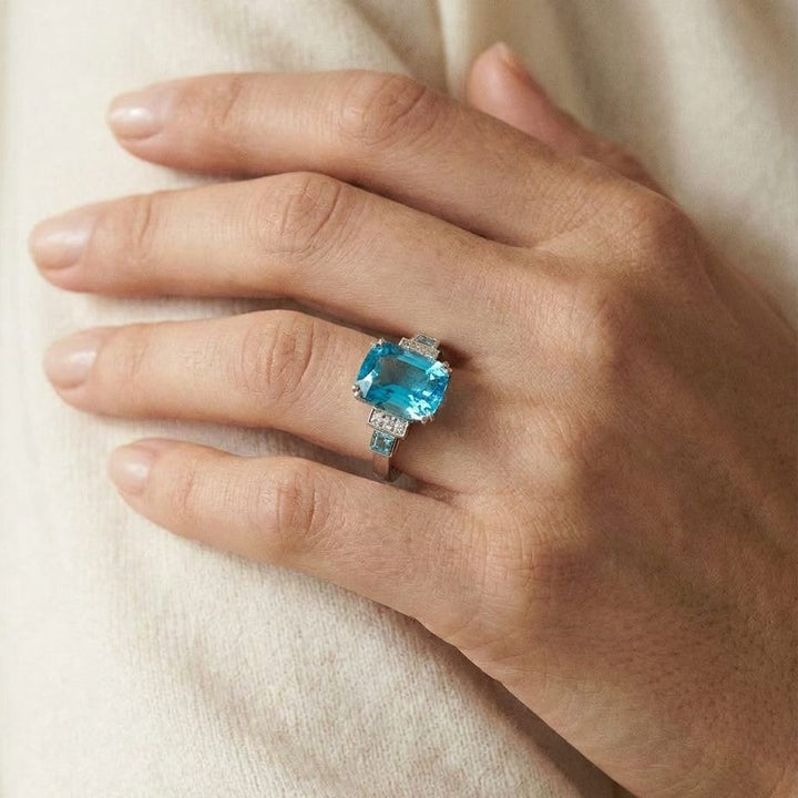 Swiss Blue Topaz and Diamond Step Ring 0.03ctw, worn on hand, close-up