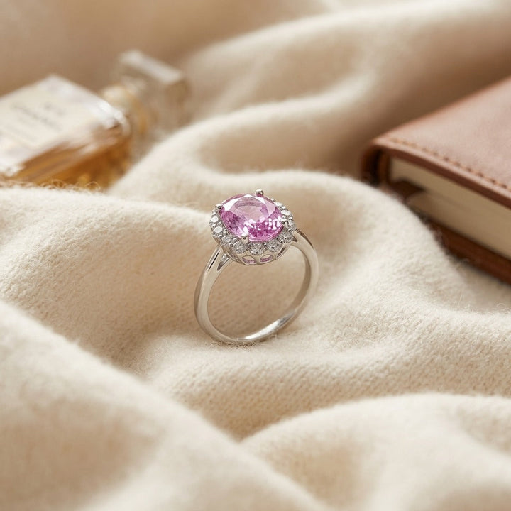 Oval Pink Sapphire & Diamond Halo Ring in 14K White Gold - flat lay
