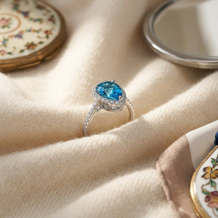 Blue Topaz & Diamond Pear Shape Halo Ring in 14K White Gold - flat lay