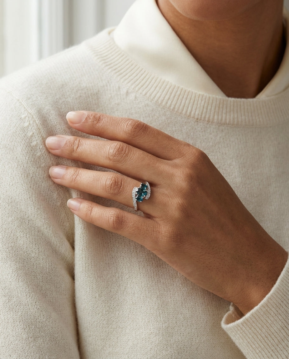 London Blue Topaz Three Stone Swirl Ring in 14k White Gold 0.13ctw, worn close-up portrait