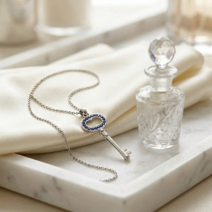 Sapphire Pendant in 14K White Gold, on marble vanity tray with silk