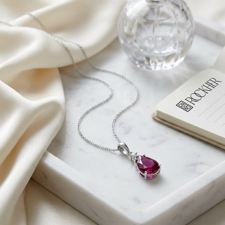 Rhodolite Garnet Pendant in 14K White Gold, on marble vanity tray with silk