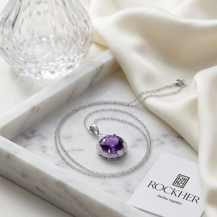Amethyst Round Brilliant Halo Pendant in 14K White Gold, on marble vanity tray with silk