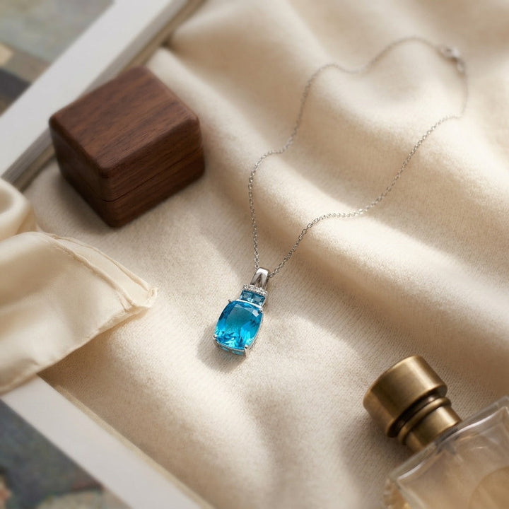Swiss Blue Topaz & Diamond Pendant with Color-Accent Bail in 14K White Gold - flat lay