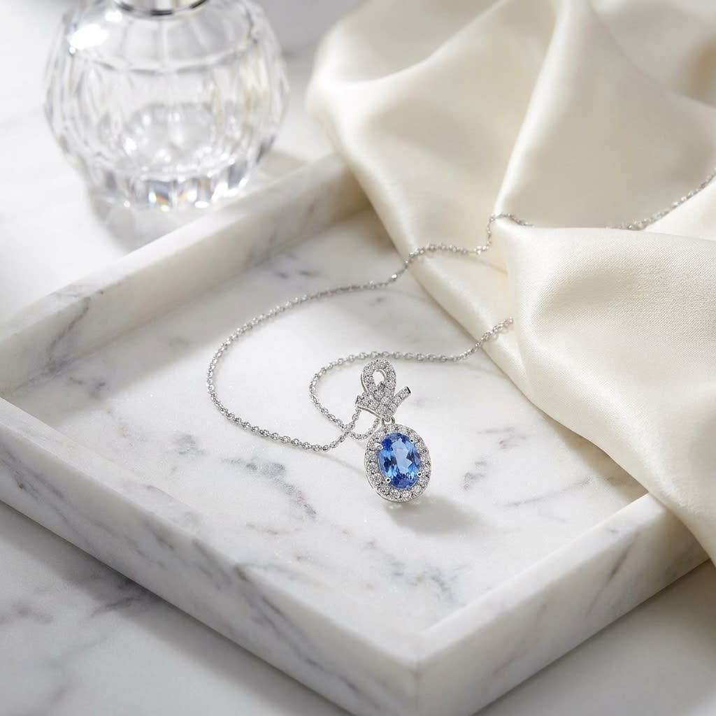 Sapphire Oval Halo Pendant in 14K White Gold, on marble vanity tray with silk