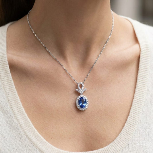 Tanzanite Oval Halo Pendant in 14K White Gold, worn close-up portrait