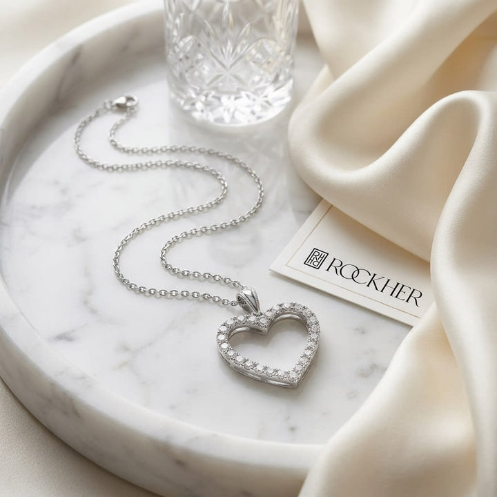 Natural Diamond Heart Shape Pendant in 14K White Gold, on marble vanity tray with silk