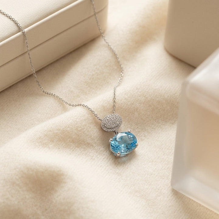 Blue Topaz Oval & Diamond 1/16ctw Pendant Set with Chain in 14K White Gold - flat lay