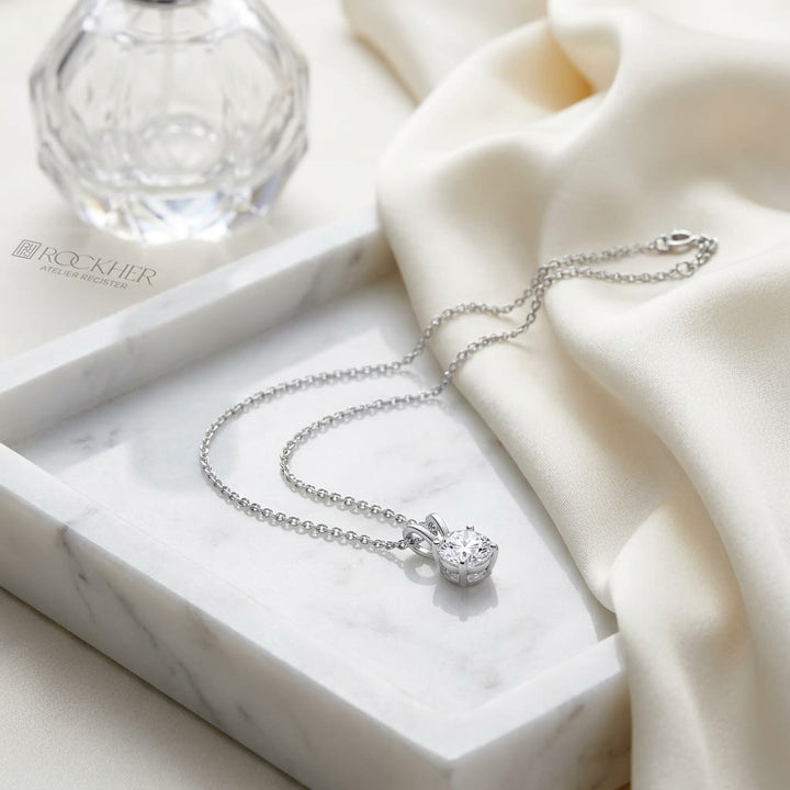 Natural Diamond Round Brilliant Solitaire Pendant in 14K White Gold, 2 ct. t.w., on marble vanity tray with silk
