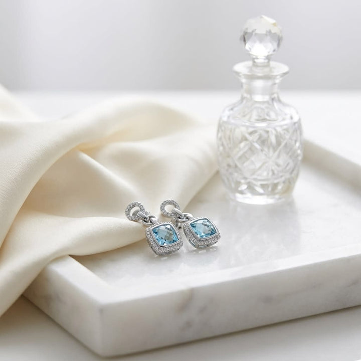 Aquamarine And Diamond Earrings in 14K White Gold, on marble vanity tray with silk