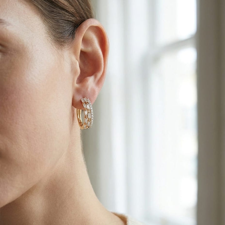 Diamond Baguette And Round Brilliant Multi-row Oval Hinged Hoop Earring in 14K White Gold, worn close-up portrait
