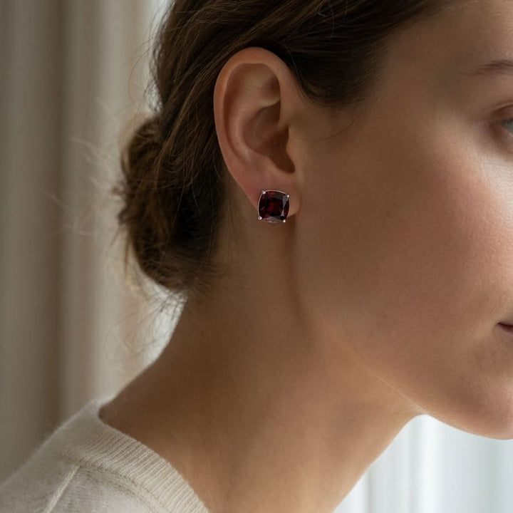 Garnet Cushion Stud Earrings in 14K White Gold, worn close-up portrait