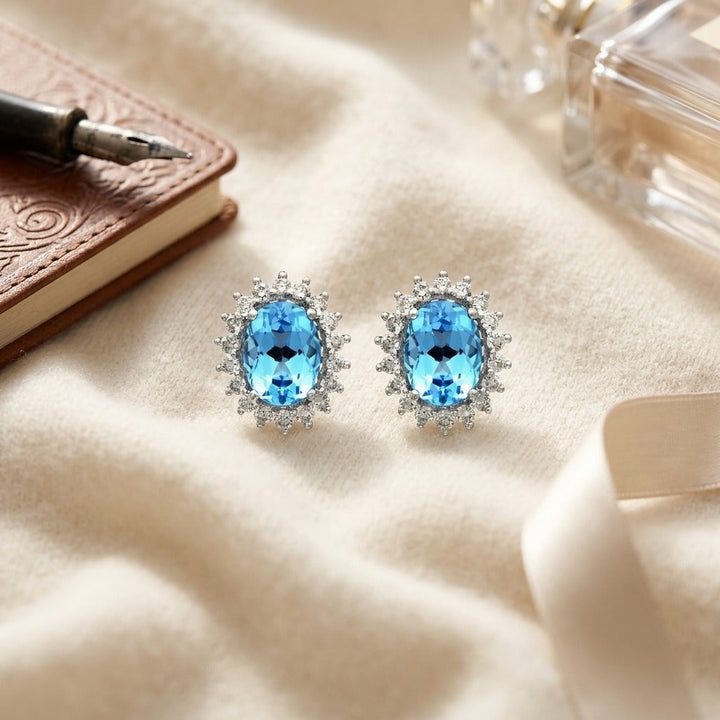Blue Topaz & Diamond Prong Oval Halo Stud Earrings in 14K White Gold - flat lay