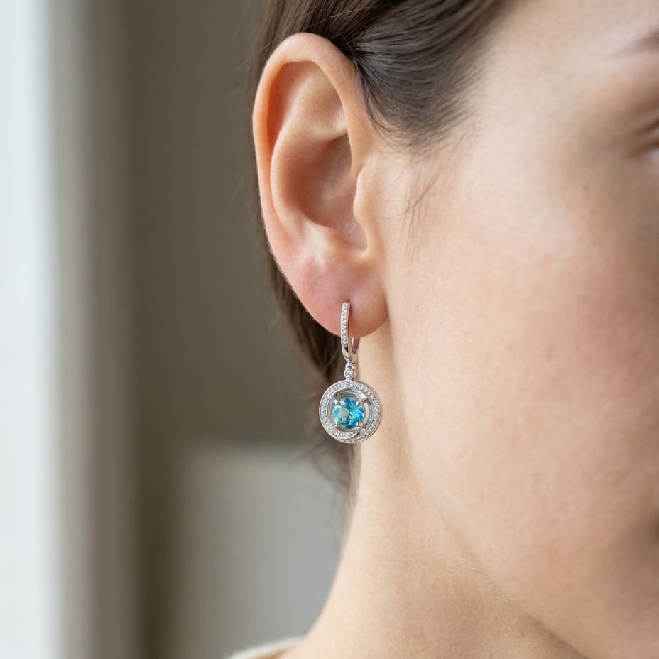 Blue Topaz And Diamond Swirl Dangling Earrings in 14K White Gold, worn close-up portrait