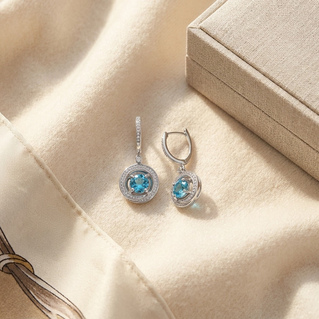 Blue Topaz & Diamond Swirl Dangling Earrings in 14K White Gold - flat lay