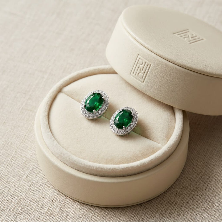 Emerald Oval Stud Earrings in 14K White Gold, in navy velvet jewelry box
