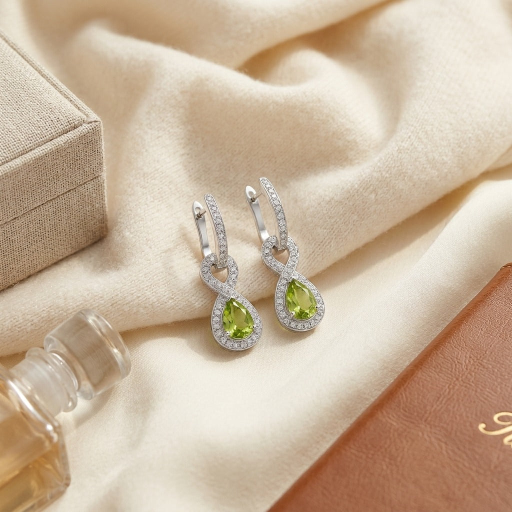 Peridot & Diamond Infinity Dangle Earrings in 14K White Gold - flat lay
