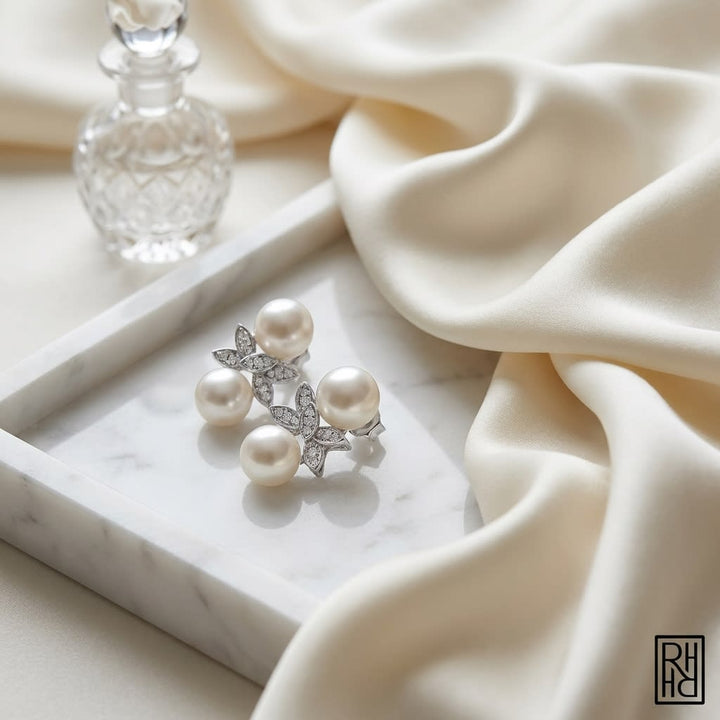 Fresh Water Pearl And Diamond Butterfly Earring in 14K White Gold, on marble vanity tray with silk