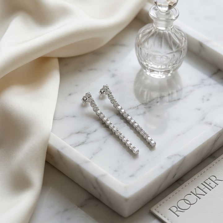 Diamond Linear Drop Earrings in 14K White Gold, on marble vanity tray with silk