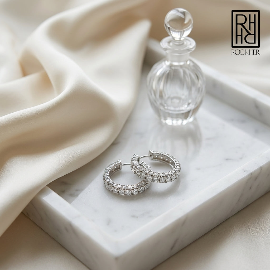 Diamond Hinged Back Huggie Hoop Earrings in 14k White Gold 0.42ctw, on marble vanity tray with silk