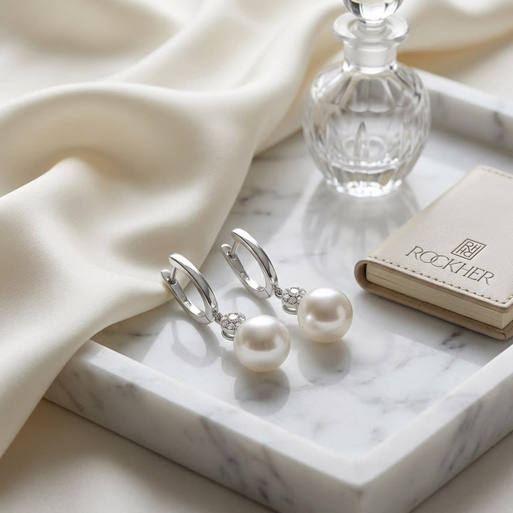 Pearl And Diamond Pave Disk Dangle Earring in 14K White Gold, on marble vanity tray with silk