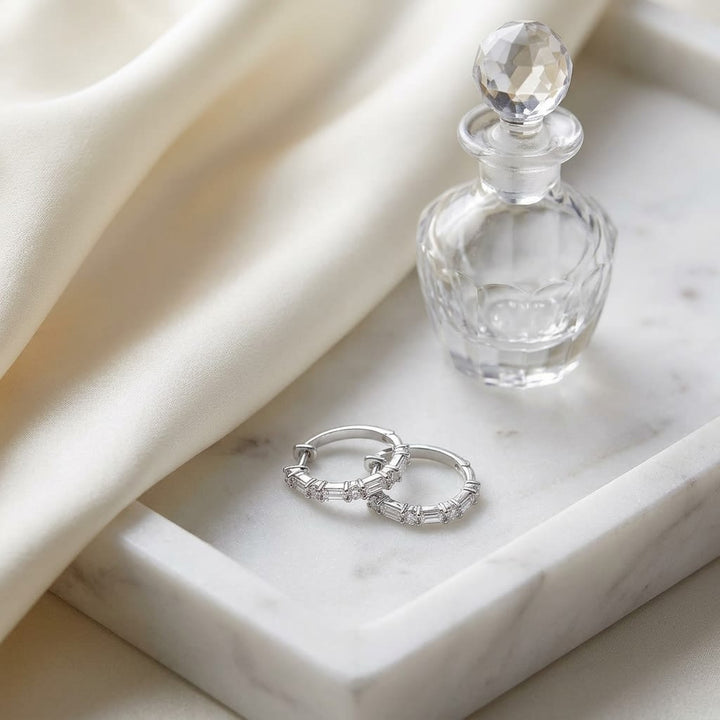 Diamond Baguette And Round Hoop Earrings in 14K White Gold, on marble vanity tray with silk