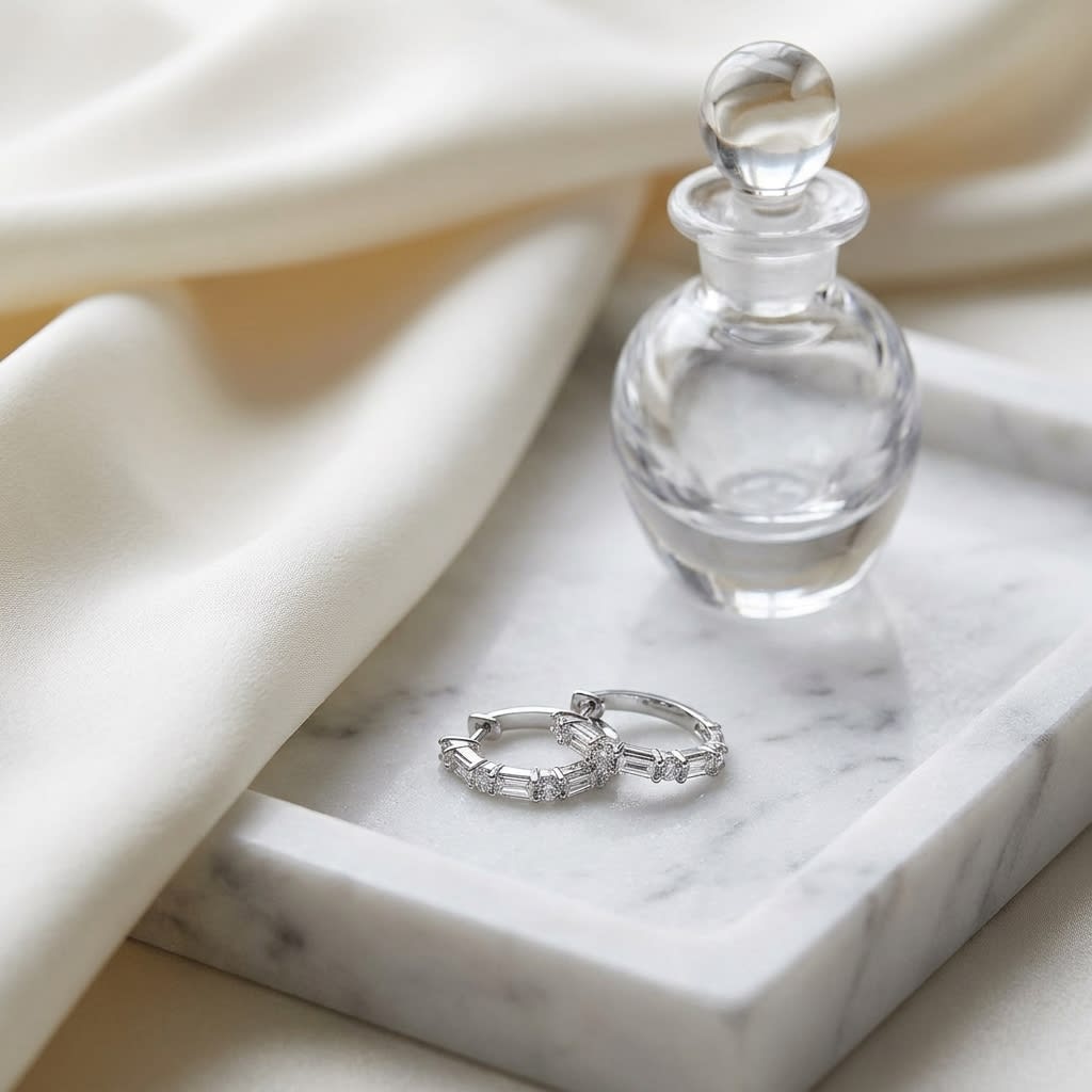 Diamond Baguette And Round Hoop Earrings in 14K White Gold, on marble vanity tray with silk