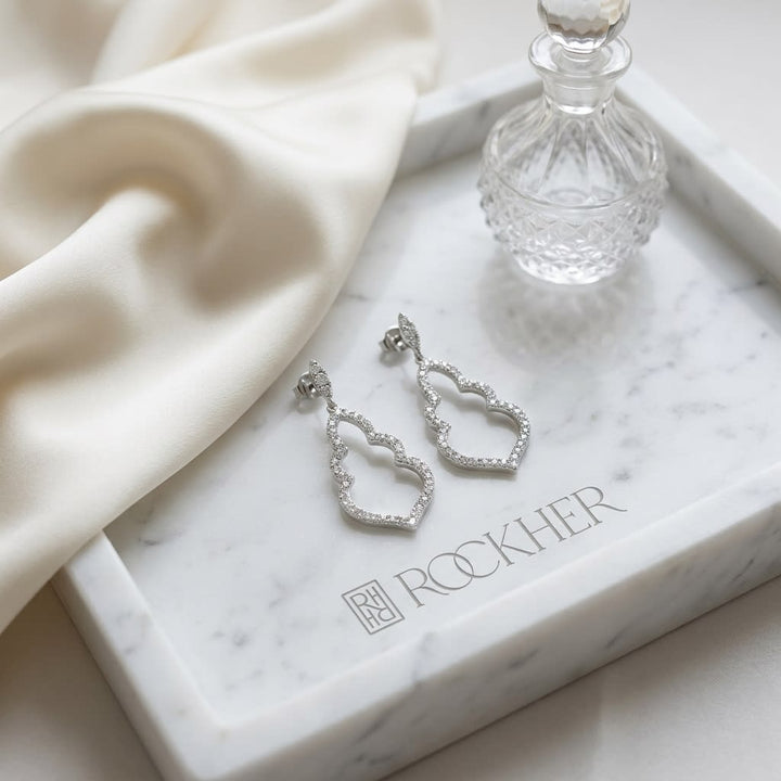 Diamond Open Damask Dangle Earrings in 14K White Gold, on marble vanity tray with silk
