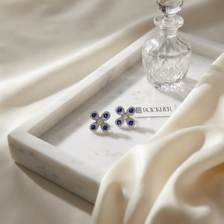 Sapphire and Diamond Clover Floral Stud Earrings in 14k White Gold 0.08ctw, on marble vanity tray with silk