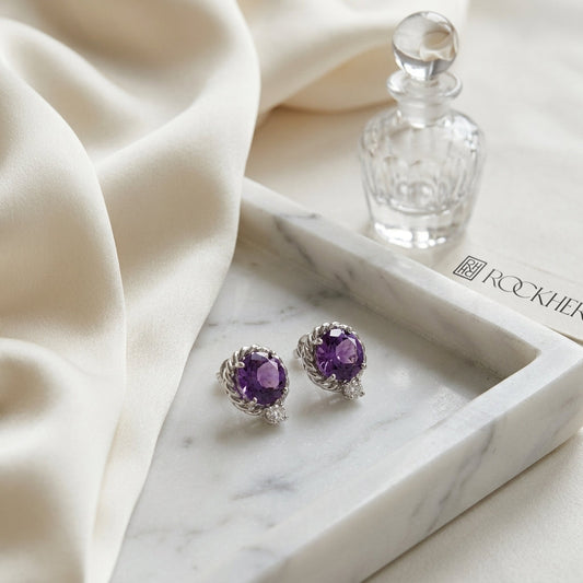 Amethyst and Diamond Ripple Edge Halo Stud Earrings in 14k White Gold 0.19ctw, on marble vanity tray with silk