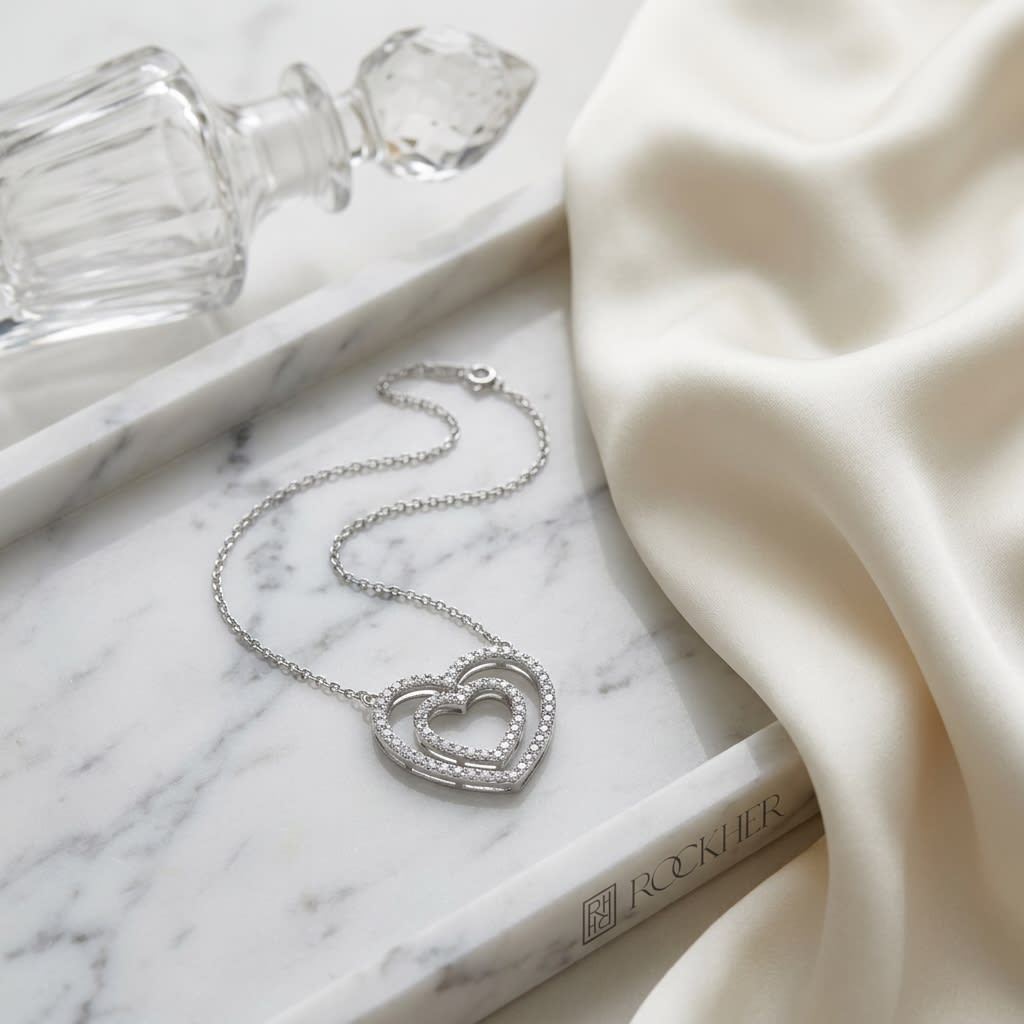 Diamond Double Heart Frame Necklace in 14K White Gold, on marble vanity tray with silk