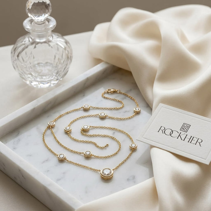 Round Diamond Bezel Necklace in 14K White Gold, on marble vanity tray with silk