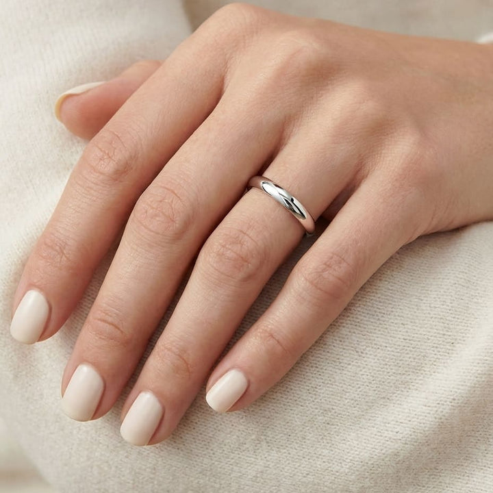 2mm Slightly Domed Traditional Oval Wedding Band in 14K White Gold, worn on hand, close-up