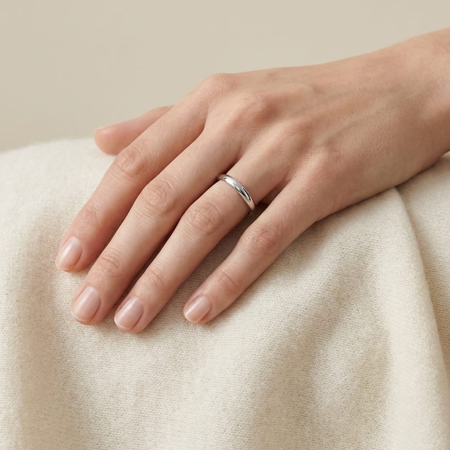 2mm Slightly Domed Traditional Oval Wedding Band in 14K White Gold, worn on hand, full view