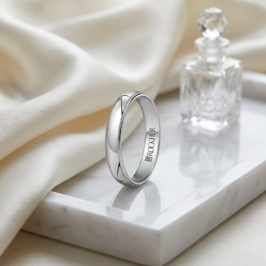 4mm Slightly Domed Traditional Oval Milgrain Wedding Band in 14K White Gold, on marble vanity tray with silk