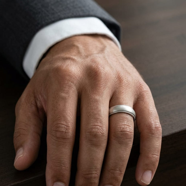 5mm Slightly Domed Traditional Oval Milgrain Wedding Band in 14K White Gold, worn on hand, masculine close-up