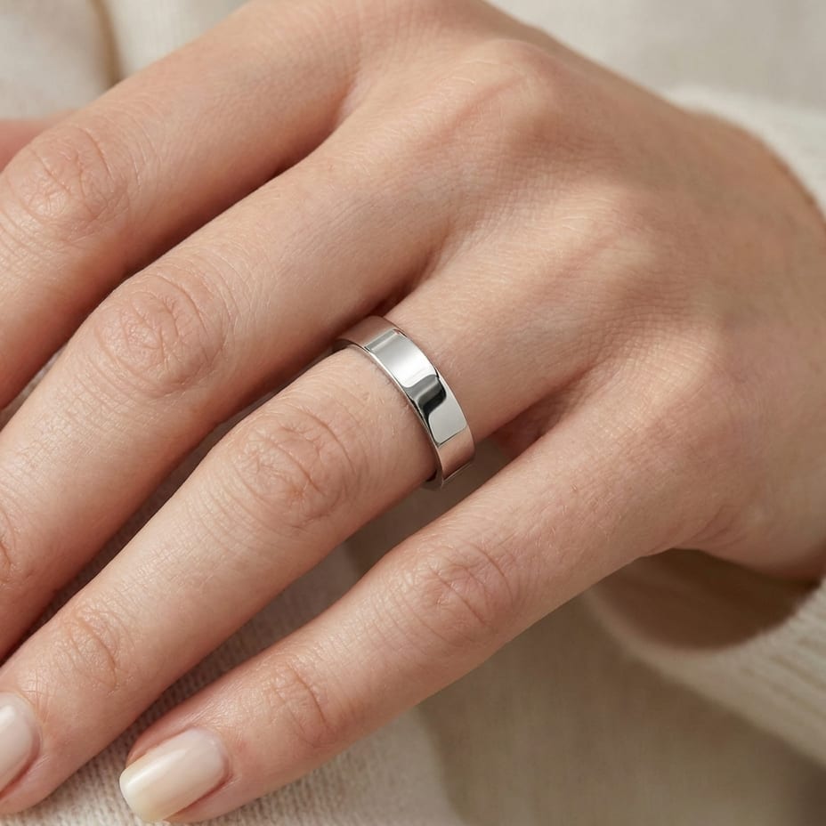 4mm Flat Comfort-Fit Wedding Band in 14K White Gold, worn on hand, close-up