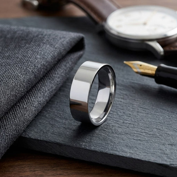 8mm Flat Comfort-Fit Wedding Band in 14K White Gold, on walnut surface with pocket square