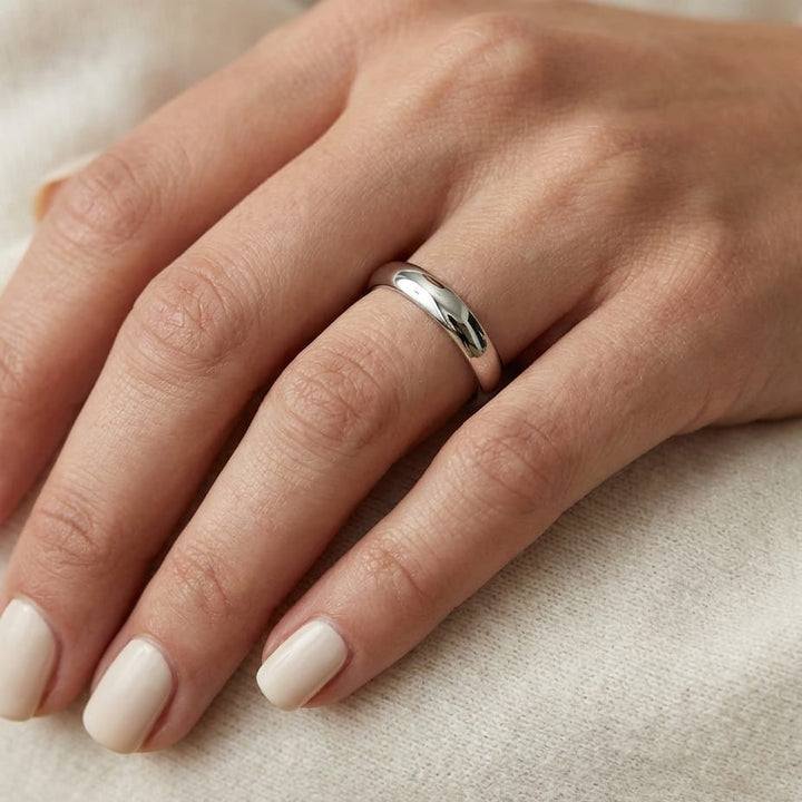 4mm High Dome Comfort-Fit Wedding Band in 14K White Gold, worn on hand, close-up