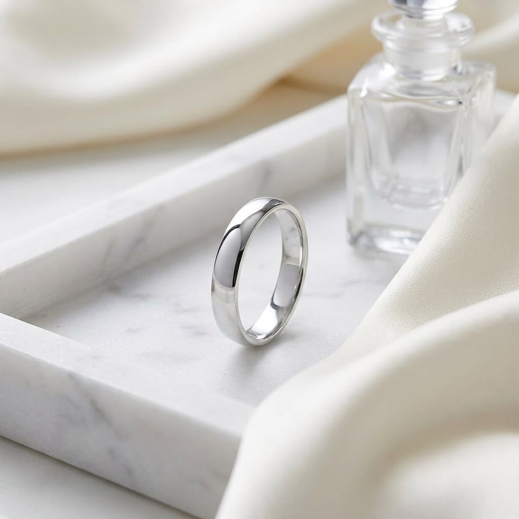 4mm Low Dome Wedding Band in 14K White Gold, on marble vanity tray with silk