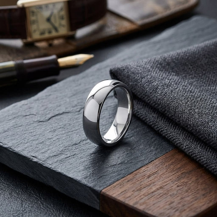 6mm Low Dome Wedding Band in 14K White Gold, on walnut surface with pocket square