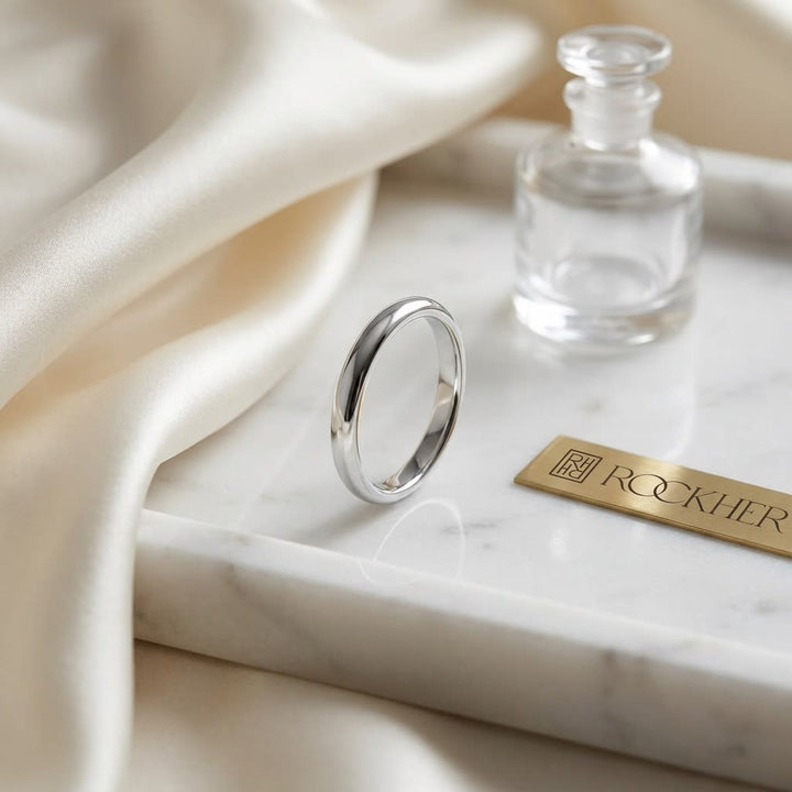 2mm Slightly Domed Comfort-Fit Wedding Band in 14K White Gold, on marble vanity tray with silk