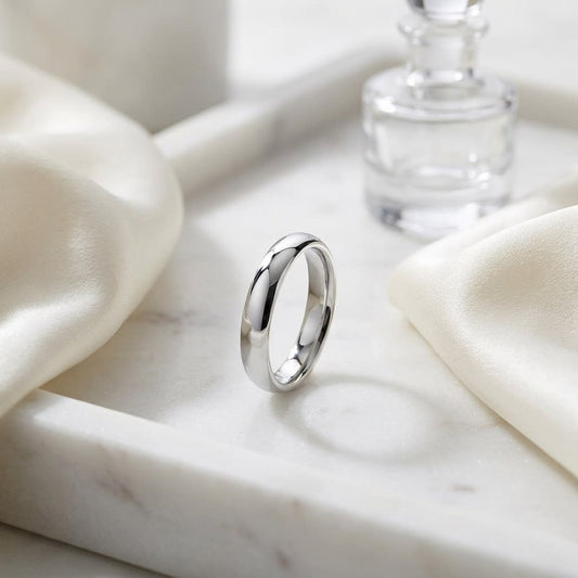 4mm Slightly Domed Super Light Comfort-Fit Wedding Band in 14K White Gold, on marble vanity tray with silk