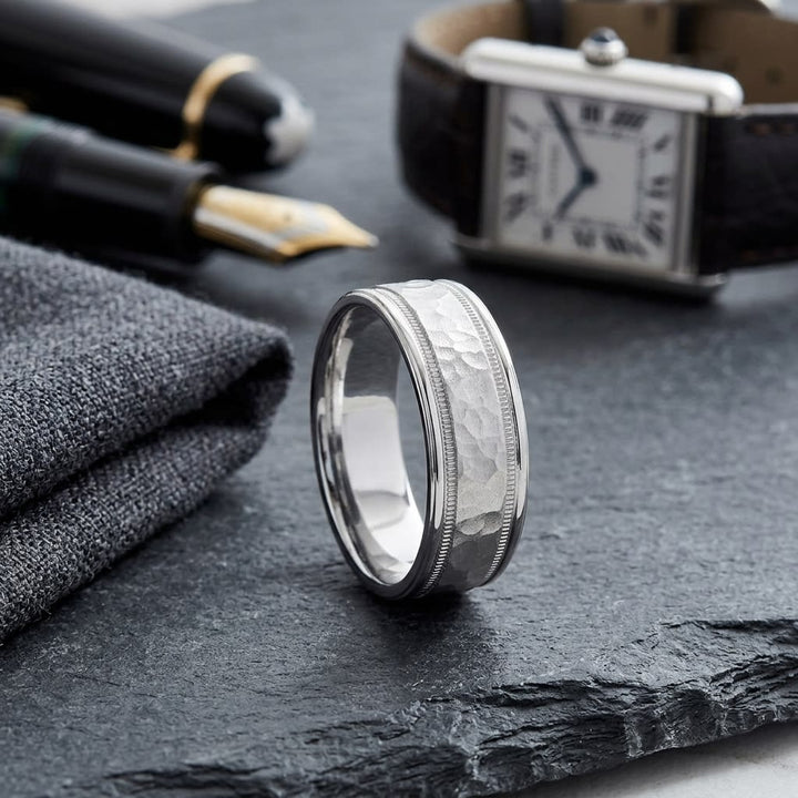 8mm Hammered Center High Polish Round Edge Carved Wedding Band in 14K White Gold, on walnut surface with pocket square