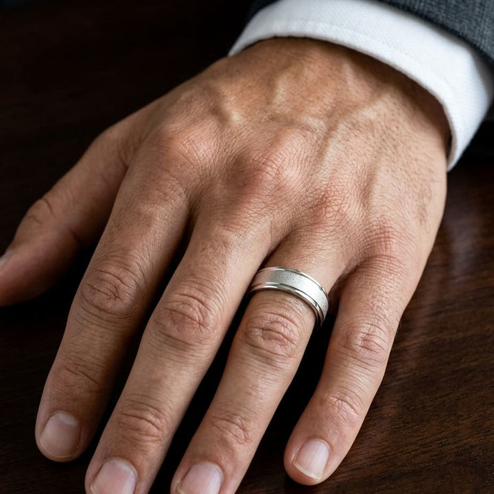 7mm Wired Finish High Polished Round Edge Carved Wedding Band in 14K White Gold, worn on hand, masculine close-up