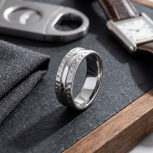 7.5mm Hammered Finish Carved Wedding Band in 14K White Gold, on walnut surface with pocket square