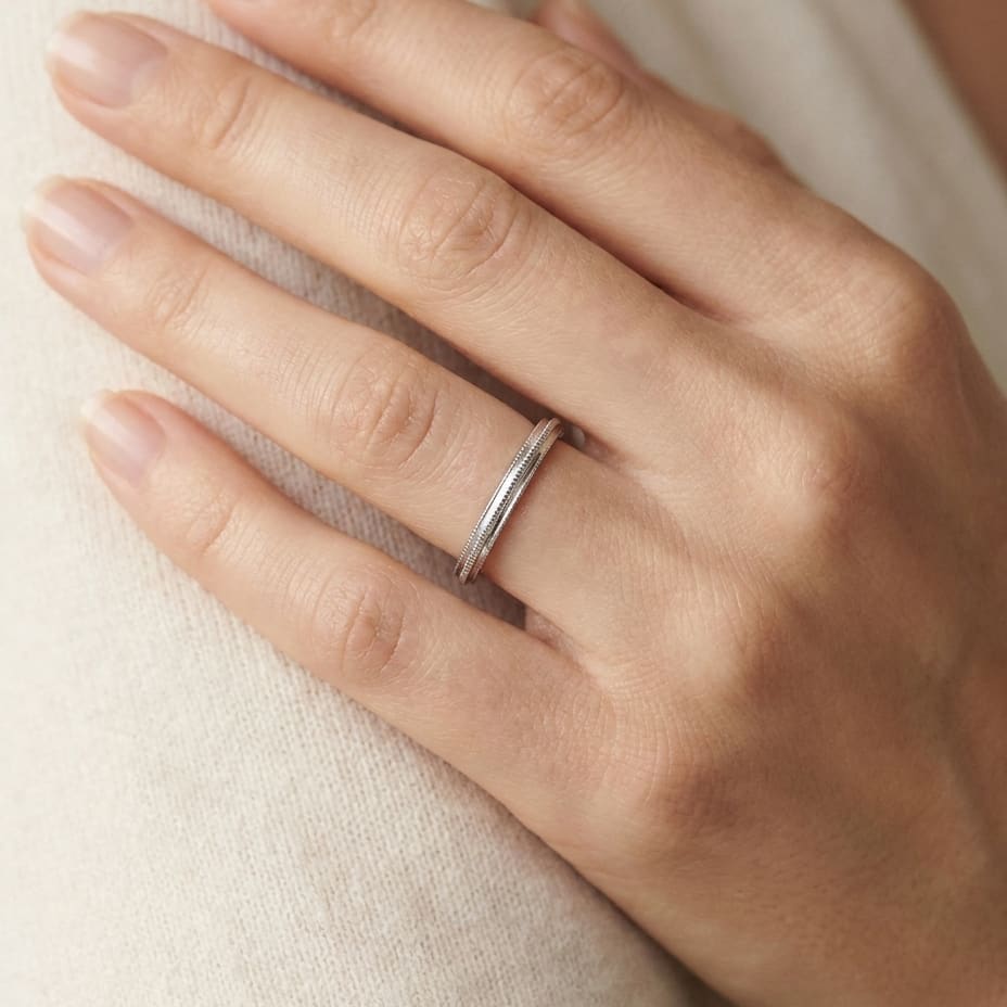 2mm High Polish Milgrain Round Edge Carved Wedding Band in 14K White Gold, worn on hand, close-up