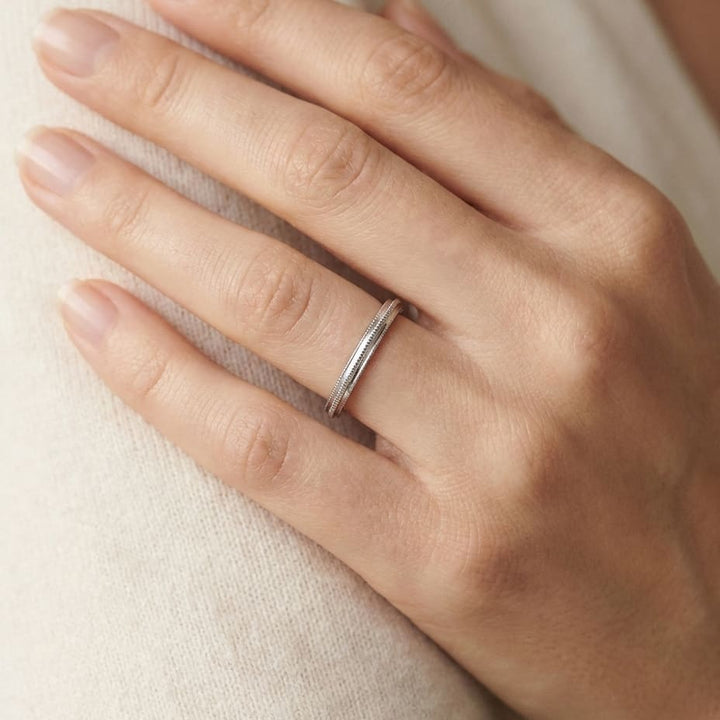 2mm High Polish Milgrain Round Edge Carved Wedding Band in 14K White Gold, worn on hand, close-up