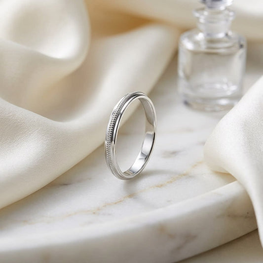 2mm High Polish Milgrain Round Edge Carved Wedding Band in 14K White Gold, on marble vanity tray with silk